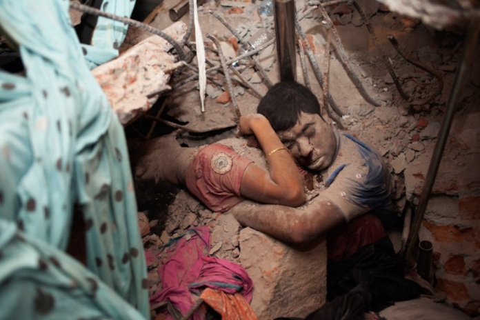 April 25, 2013. Two victims amid the rubble of a garment factory building collapse in Savar, near Dhaka, Bangladesh. Read more: http://lightbox.time.com/2013/05/08/a-final-embrace-the-most-haunting-photograph-from-bangladesh/#ixzz2SoBbxwK2